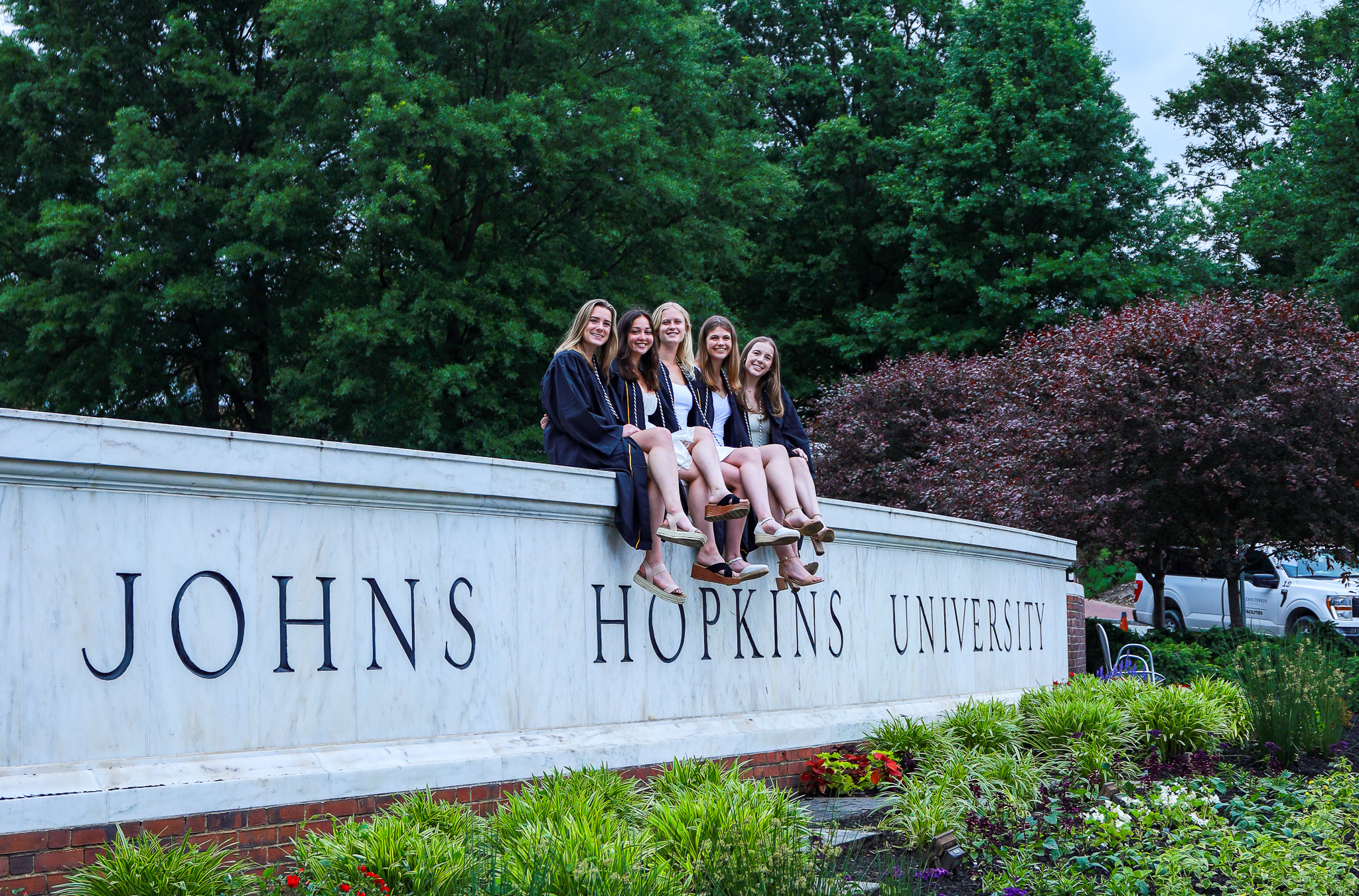 Graduation photo on Johns Hopkins Sign